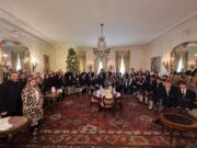 Greek-American Day School students sing carols to the Archbishop