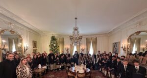Greek-American Day School students sing carols to the Archbishop